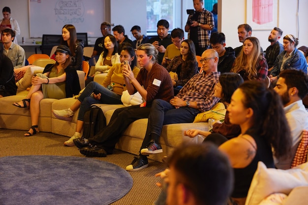 Audience members sitting on couches during presentation