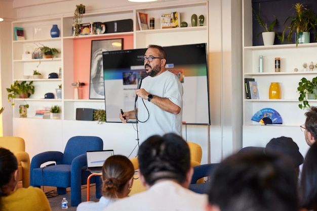 Speaker presenting to audience in modern office space